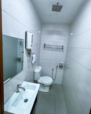 a white bathroom with a toilet and a sink at THE STARION HOTEL BUKIT BINTANG in Kuala Lumpur