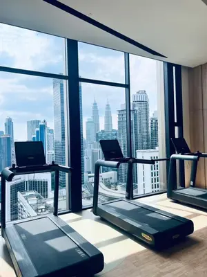 a gym with two treadmills and a view of the city at Axon Serviced Suites Kuala Lumpur in Kuala Lumpur