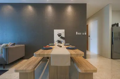 a dining room with a table and a couch at Sky Suite KLCC, Calm Sojourn in Kuala Lumpur