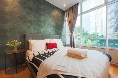 a bedroom with a bed and a large window at Sky Suite KLCC, Calm Sojourn in Kuala Lumpur
