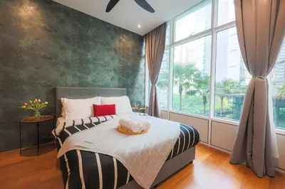 a bedroom with a bed with a hat on it at Sky Suite KLCC, Calm Sojourn in Kuala Lumpur