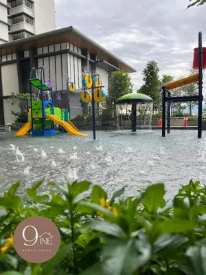 a playground is covered in water in front of a building at TF009 - Lavile Sunway Velocity KL View in Kuala Lumpur