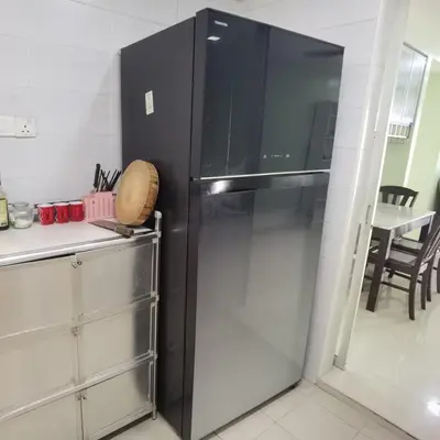 a black refrigerator in a kitchen with a table at Warisan cityview jalan cheras 56000KL in Kuala Lumpur