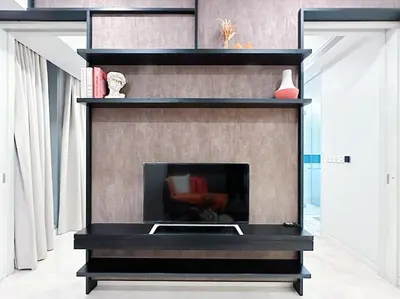 a fireplace in a living room with black shelves at Luxury Suites at Tropicana Residences KLCC by VV in Kuala Lumpur
