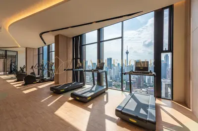 a gym with cardio equipment and a view of the city at Axon Premier Suites Kuala Lumpur in Kuala Lumpur