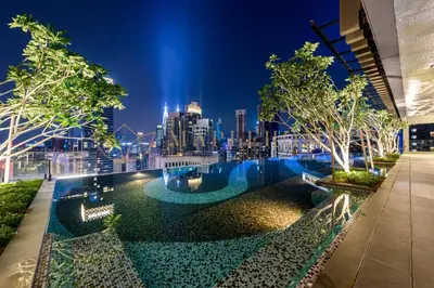 a view of a city skyline at night with a pool at Axon Premier Suites Kuala Lumpur in Kuala Lumpur