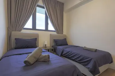 a bedroom with two beds and a window at Lovely 3-bedroom w pool 7 pax - Jalan Cheras in Kuala Lumpur