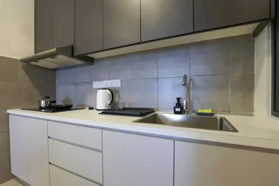 a kitchen with a sink and a counter top at Lovely 3-bedroom w pool 7 pax - Jalan Cheras in Kuala Lumpur
