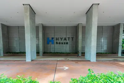 a building with pillars in front of a building at Arcoris Mont Kiara 163 in Kuala Lumpur