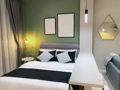 a bedroom with a bed and two pictures on the wall at Arcoris Mont Kiara 163 in Kuala Lumpur