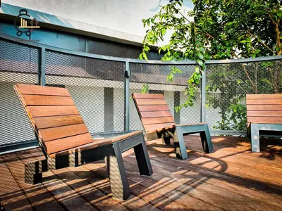 two benches sitting on a deck next to a fence at 1 min to KL Tallest Residence Heart of Klang Valley in Kuala Lumpur