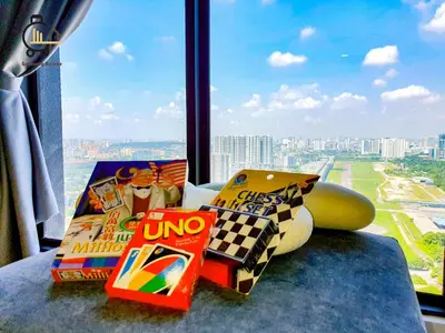 a pile of snacks on a table in front of a window at 1 min to KL Tallest Residence Heart of Klang Valley in Kuala Lumpur