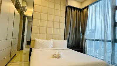 a hotel room with two pairs of slippers on a bed at Panoramic KL View @Robertson Bukit Bintang 40f in Kuala Lumpur