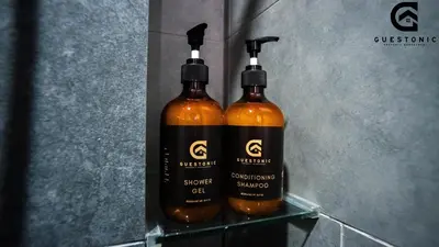 two bottles of wine sitting on a shelf at NeuSuite Cozy Studio by GUESTONIC in Kuala Lumpur