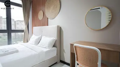 a bedroom with a bed and a mirror and a desk at NeuSuite Cozy Studio by GUESTONIC in Kuala Lumpur