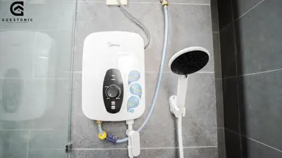 a soap dispenser on the wall of a shower at NeuSuite Cozy Studio by GUESTONIC in Kuala Lumpur