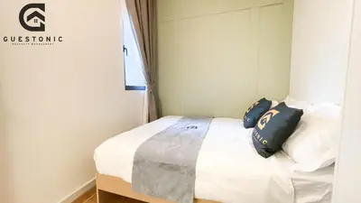 a bedroom with a bed with two pillows on it at NeuSuite Cozy Studio by GUESTONIC in Kuala Lumpur