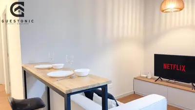 a dining room with a table and a tv at NeuSuite Cozy Studio by GUESTONIC in Kuala Lumpur