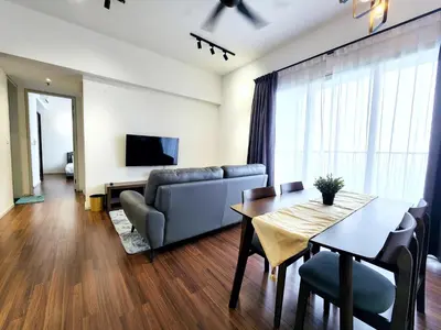 a living room with a table and a couch at Infini Suites@ UNA Residences, Sunway Velocity KL in Kuala Lumpur