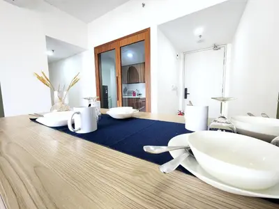 a bathroom with white sinks and a blue rug at Infini Suites@ UNA Residences, Sunway Velocity KL in Kuala Lumpur