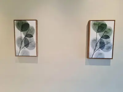 two framed pictures of leaves on a wall at Homeaway 2R1B 10 mins to KLCC in Kuala Lumpur