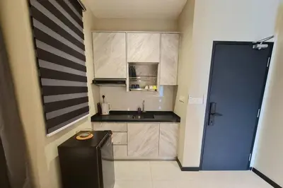 a small kitchen with a sink and a refrigerator at Homeaway 2R1B 10 mins to KLCC in Kuala Lumpur