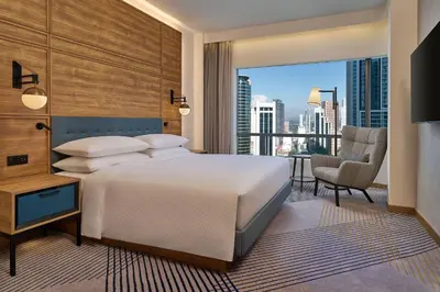 a bedroom with a bed and a view of the city at Four Points by Sheraton Kuala Lumpur, City Centre in Kuala Lumpur