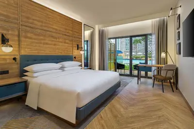 a bedroom with a bed and a desk and a table at Four Points by Sheraton Kuala Lumpur, City Centre in Kuala Lumpur