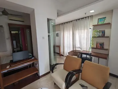 a living room with two chairs and a television at Damansara Studio in Kuala Lumpur