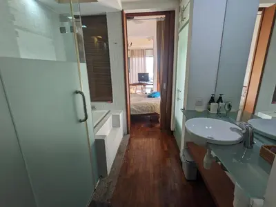 a bathroom with two sinks and a walk in shower at Damansara Studio in Kuala Lumpur
