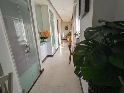 a hallway with a plant and a glass door at Damansara Studio in Kuala Lumpur
