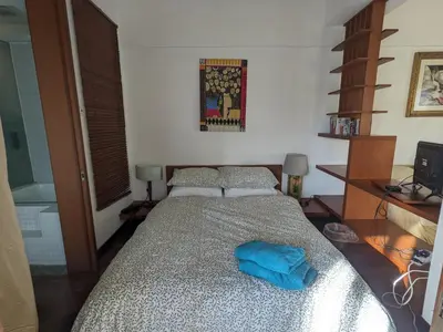 a bedroom with a bed with a blue towel on it at Damansara Studio in Kuala Lumpur