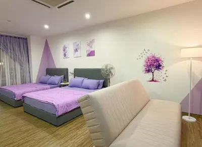 a bedroom with two beds and a couch at SETAPAK CENTRAL KL - Lavender Zetapark Suite in Kuala Lumpur