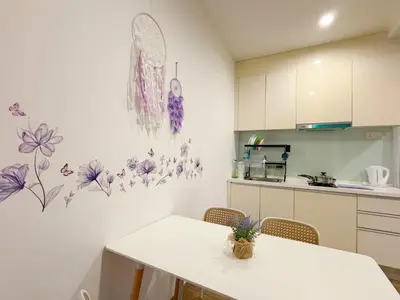 a kitchen with a table and some flowers on the wall at SETAPAK CENTRAL KL - Lavender Zetapark Suite in Kuala Lumpur