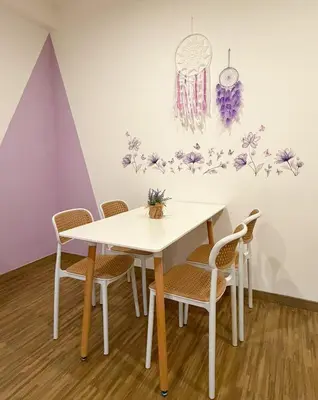 a table and chairs in a room with flowers on the wall at SETAPAK CENTRAL KL - Lavender Zetapark Suite in Kuala Lumpur