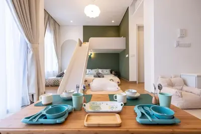 a dining room table with blue dishes on it at Cute Dinosaur Kids Theme@Lucentia LalaPort BBCC in Kuala Lumpur