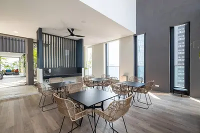 a dining room with tables and chairs and windows at Cute Dinosaur Kids Theme@Lucentia LalaPort BBCC in Kuala Lumpur