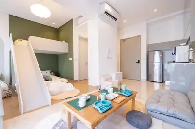 a living room with a couch and a table at Cute Dinosaur Kids Theme@Lucentia LalaPort BBCC in Kuala Lumpur