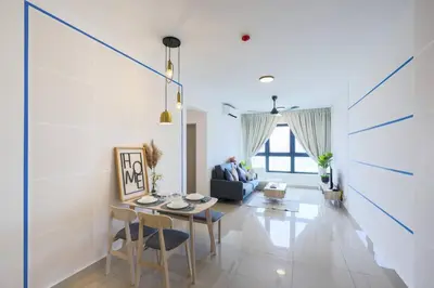 a living room with a table and a blue couch at M Vertica KL Residence in Kuala Lumpur