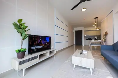 a living room with a blue couch and a tv at M Vertica KL Residence in Kuala Lumpur