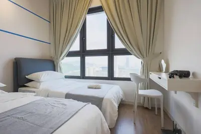 a hotel room with two beds and a window at M Vertica KL Residence in Kuala Lumpur