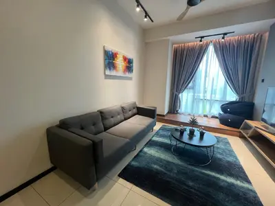 a living room with a couch and a table at Opus Residences 2 Bedroom Apartment in Kuala Lumpur