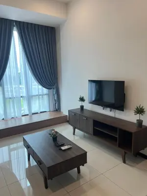 a living room with a tv and a coffee table at Opus Residences 2 Bedroom Apartment in Kuala Lumpur