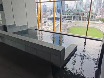 a building with a pool of water in front of a window at Opus Residences 2 Bedroom Apartment in Kuala Lumpur