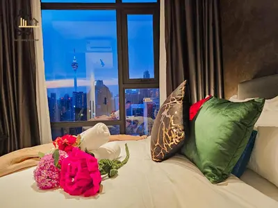 a bed with flowers on it with a window at 1 min to Pavilion KL Heart of Bukit Bintang by GBS in Kuala Lumpur