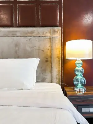 a bedroom with a bed and a lamp on a table at KL Tower KLCC Pavilion by Kimiro in Kuala Lumpur