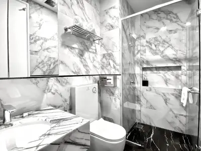 a marble bathroom with a toilet and a sink at KL Tower KLCC Pavilion by Kimiro in Kuala Lumpur