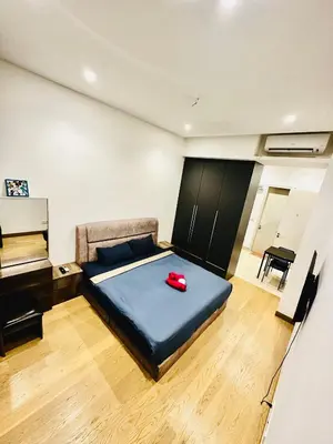 a bedroom with a blue bed and a piano at BBCC APARTMENT AT LUCENTIA 2 in Kuala Lumpur