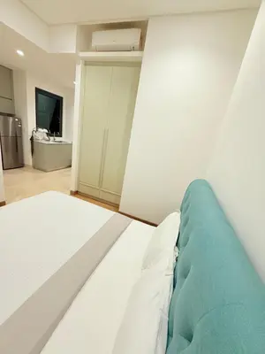 a bedroom with a bed with a blue blanket at BBCC APARTMENT AT LUCENTIA 2 in Kuala Lumpur