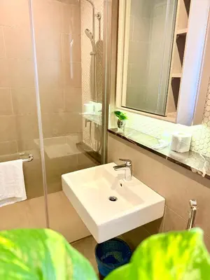 a bathroom with a white sink and a shower at BBCC APARTMENT AT LUCENTIA 2 in Kuala Lumpur